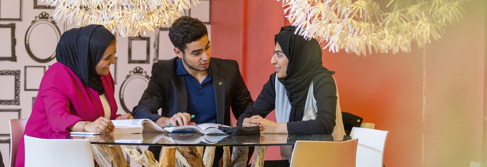 Three students using a modern study space.