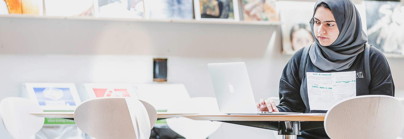A student working on a laptop in the ISC library