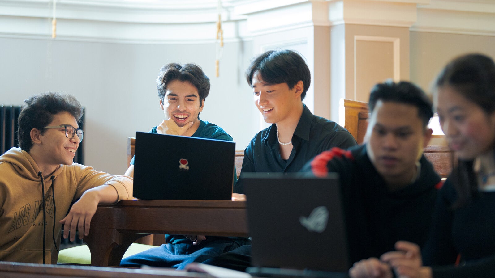 Students looking at a laptop