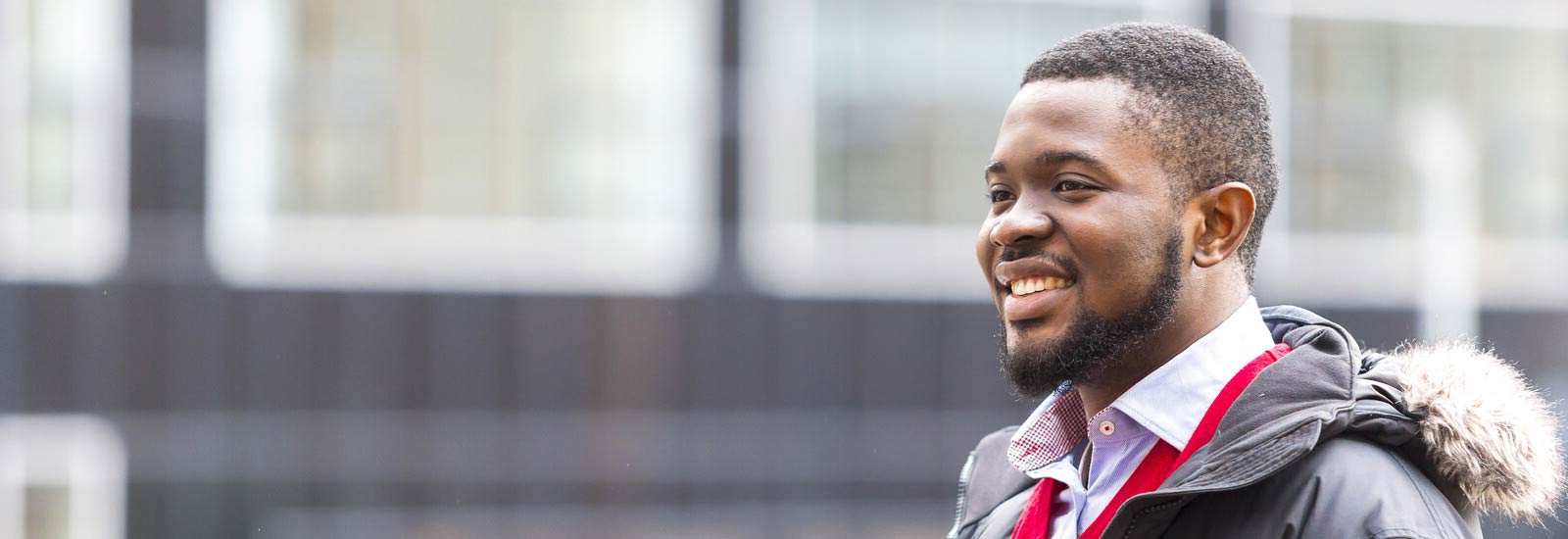 A student smiling outside campus