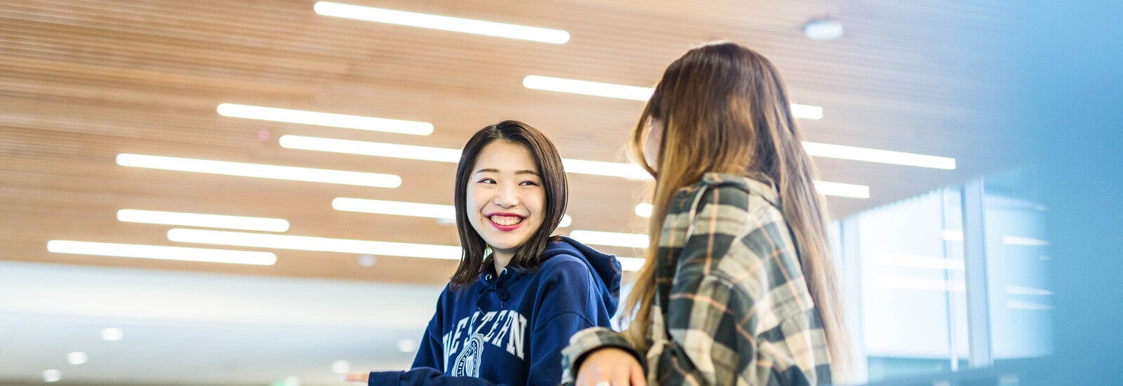 Two students laughing together on campus