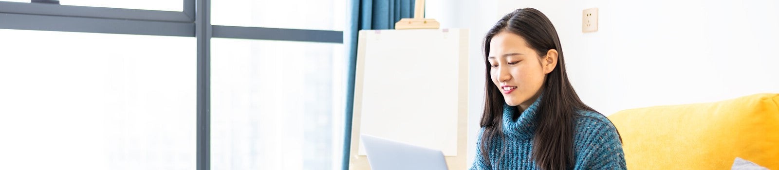 A student studying remotely on their laptop at home