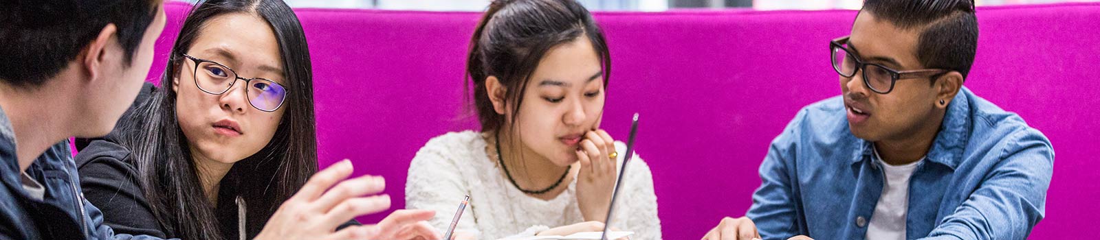A group of students working in a shared space.