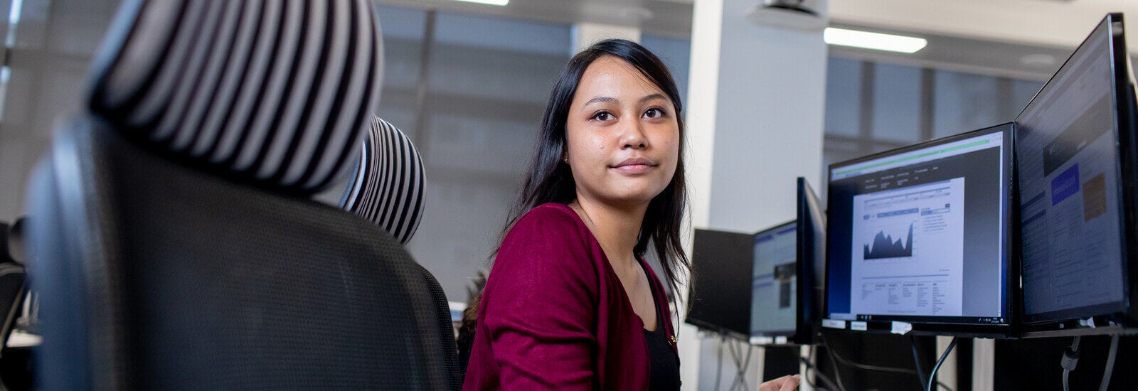 Student posing by computer