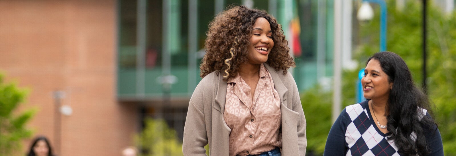 Two students walking together outside campus
