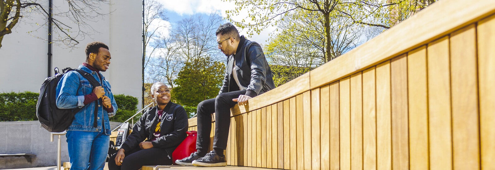 Three students hanging out on campus
