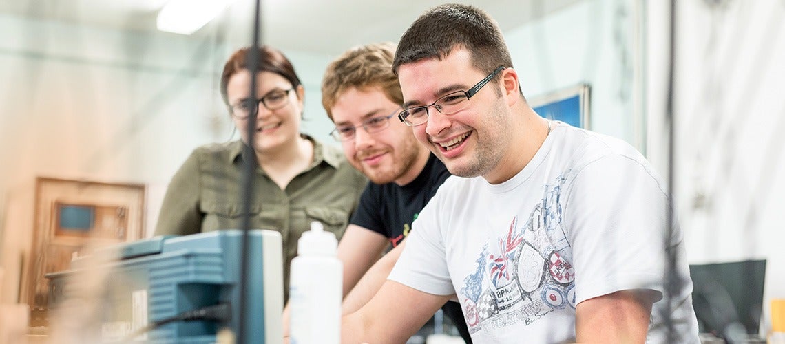 Strathclyde students smiling and working together