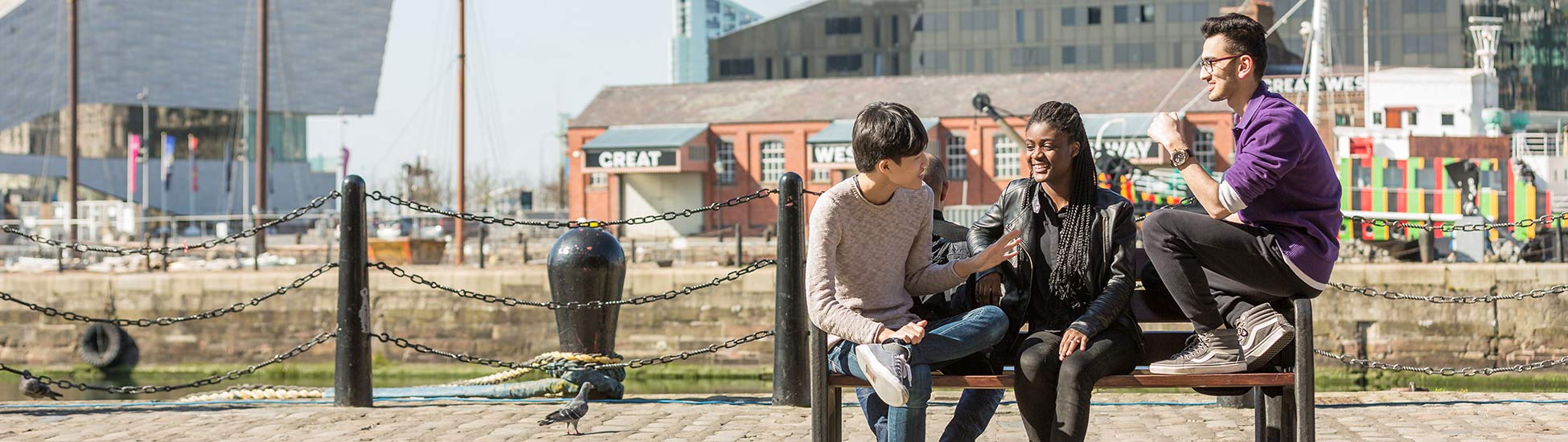 Students sitting on a bench outside a dock