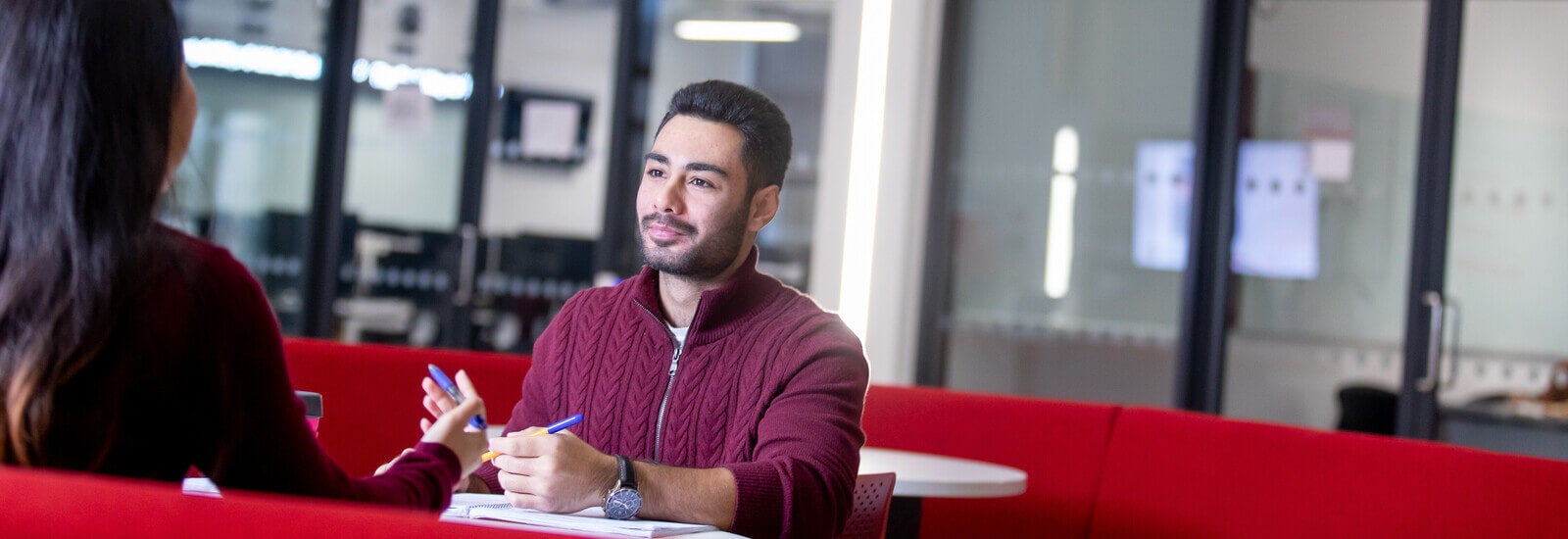 Students talking at a table on campus