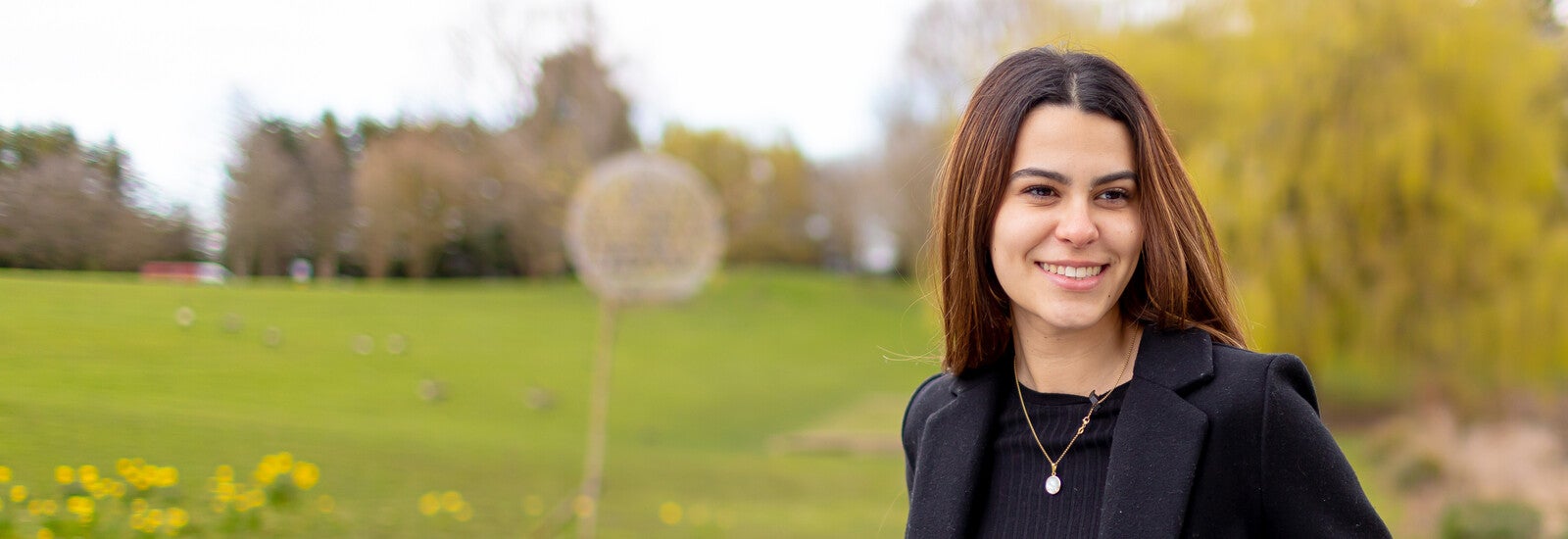 Student smiling outside campus