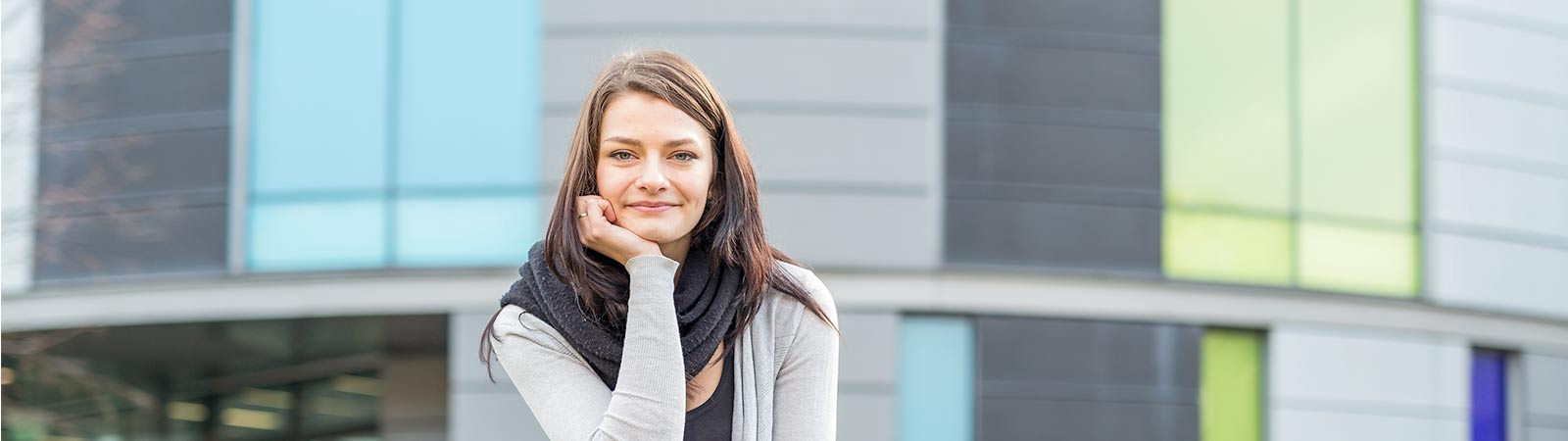 Student sitting on steps outside campus