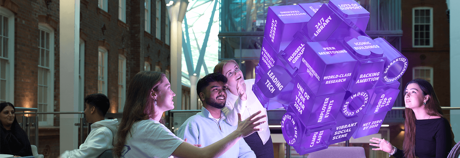 Students looking at a graphic in the shape of a Rubiks cube