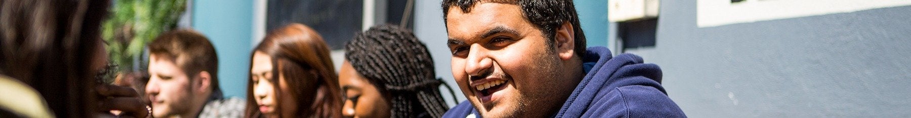 Student laughing outside campus