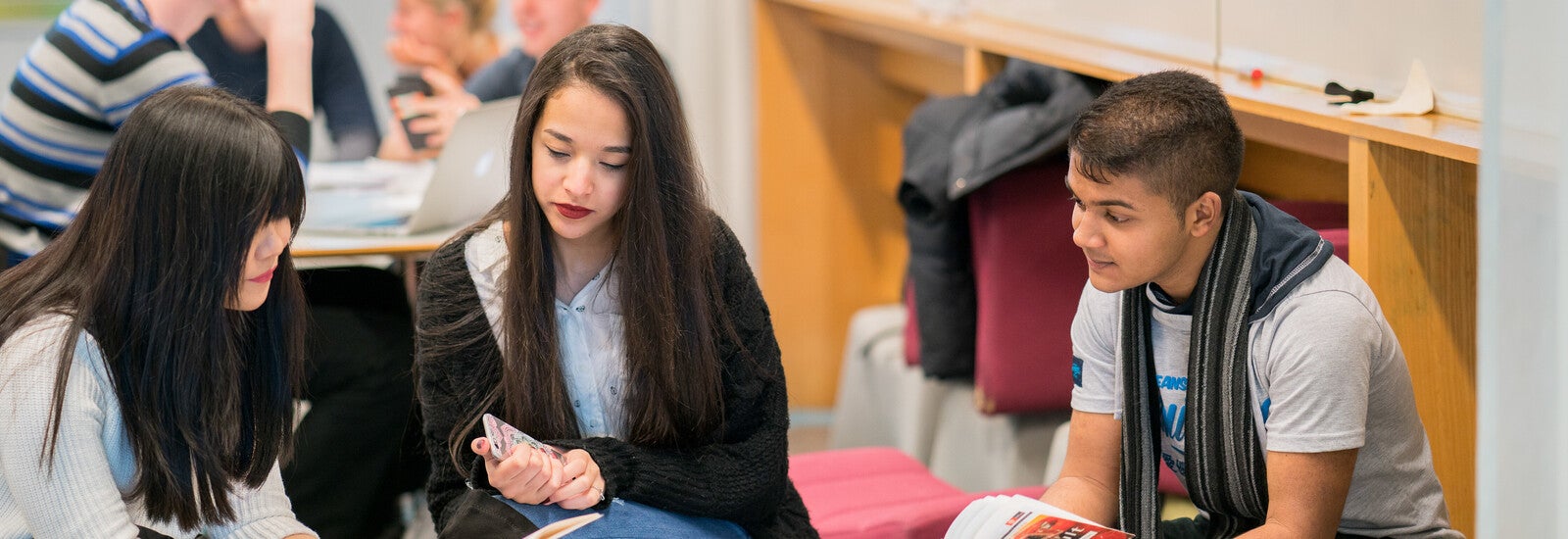 ISC students working together in the library on campus