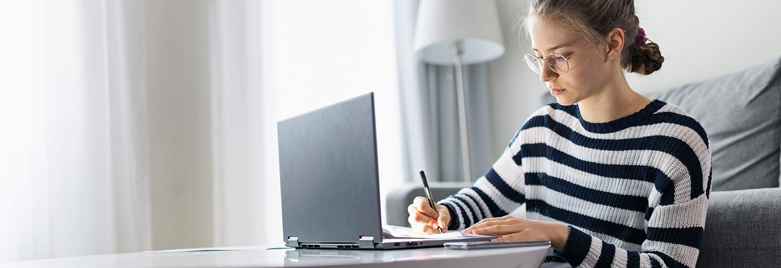 A student working remotely on a laptop at home