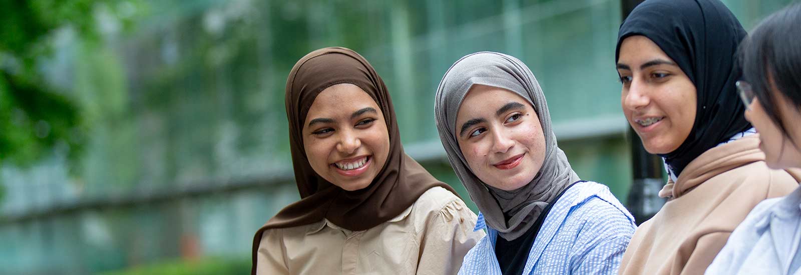 Students sat on campus laughing with each other