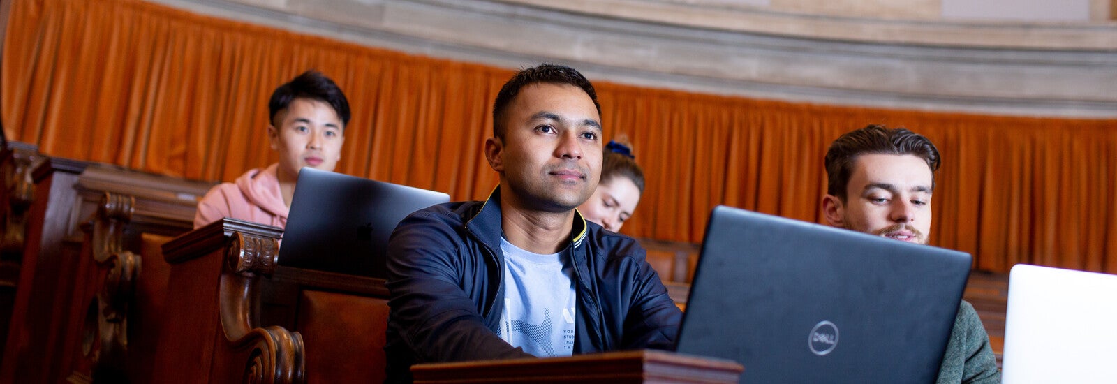 Students on laptops in lecture hall