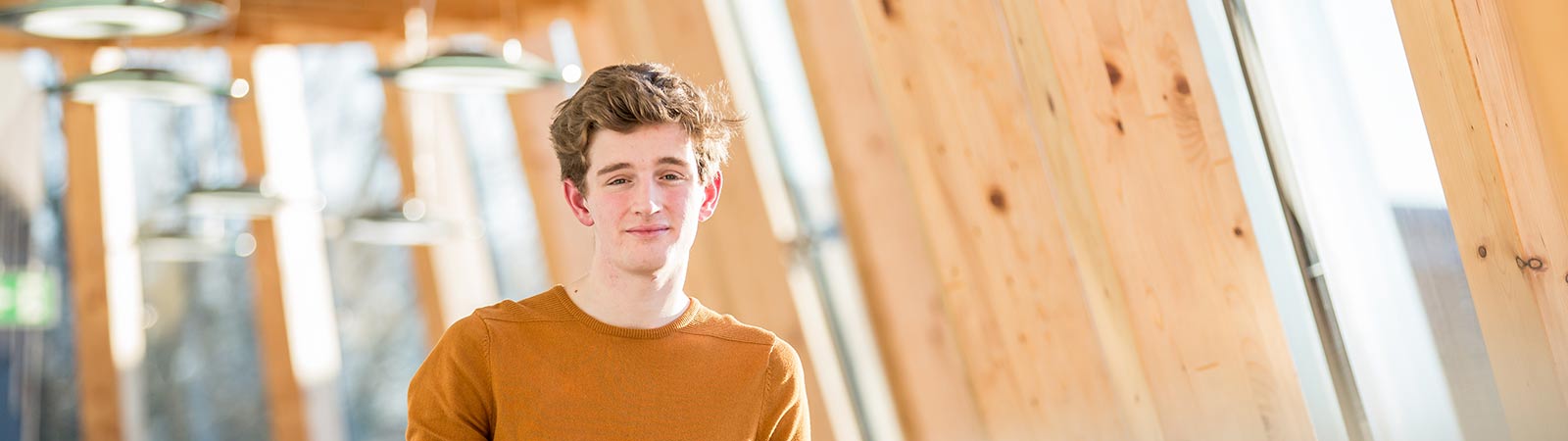 Student smiling at camera on campus