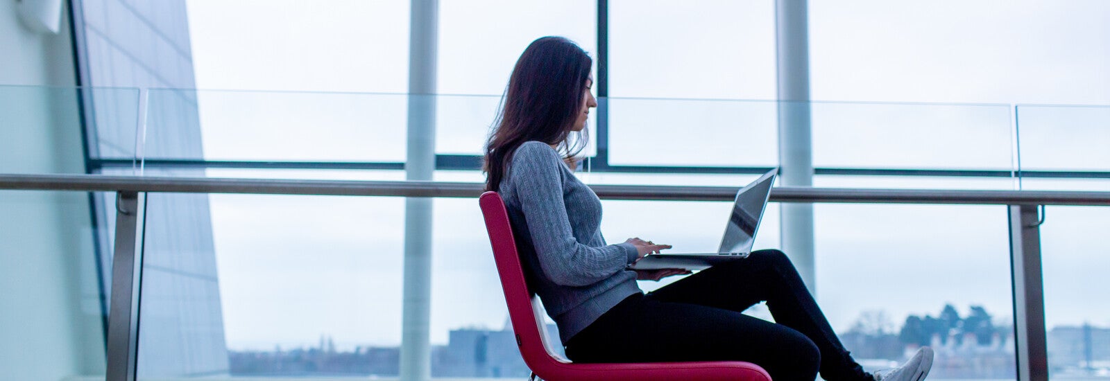 Student working on laptop on campus