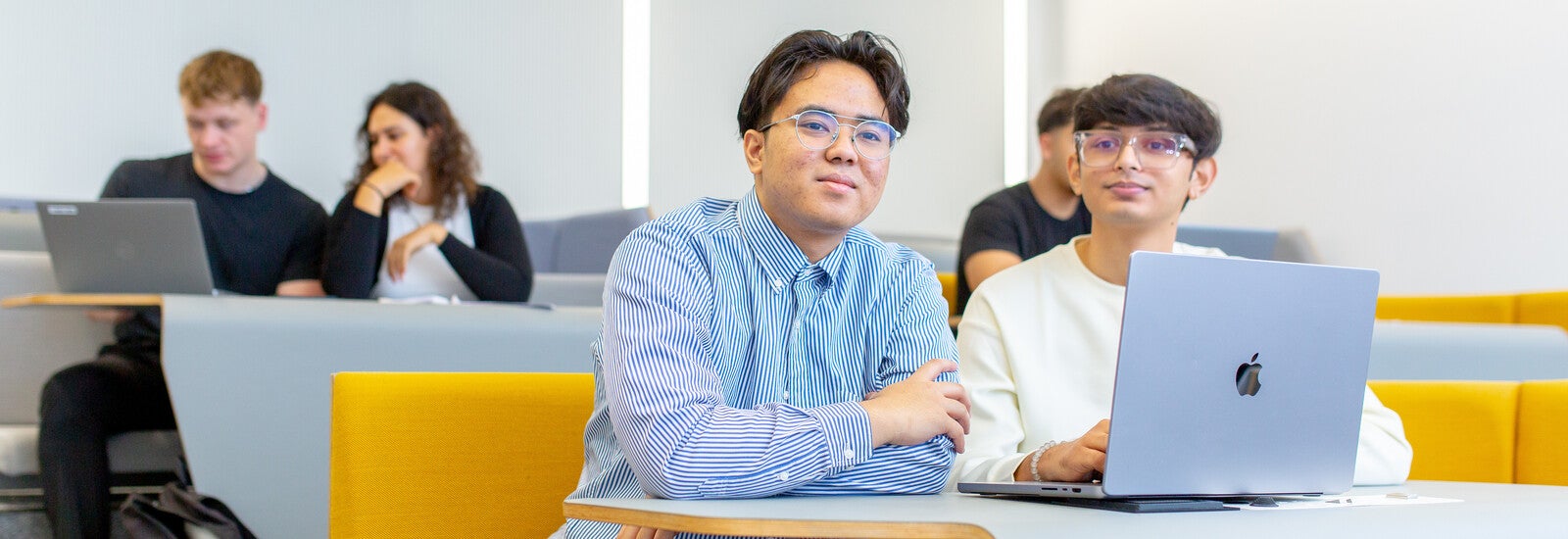 Students in class working on laptops