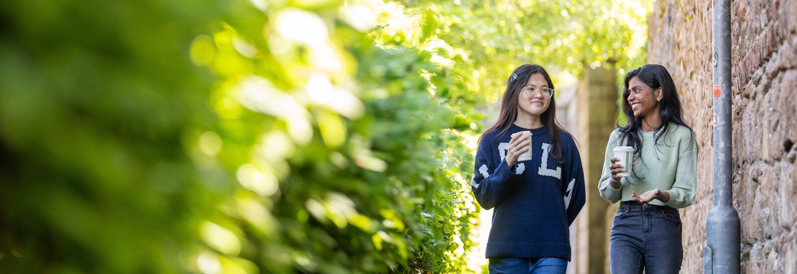 Two students talking and walking