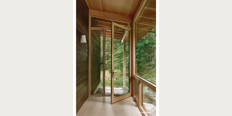 expansive windows and glass door leading outside.