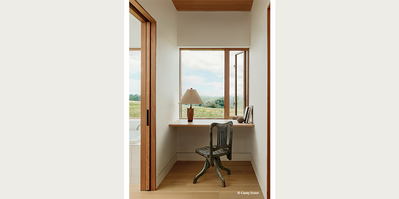 built in desk in a nook with a window view and beautiful woodwork