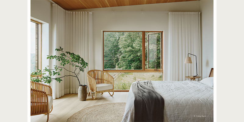 Expansive windows with beautiful woodwork in the bedroom