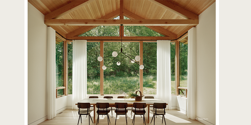 Expansive windows with beautiful woodwork in dining room
