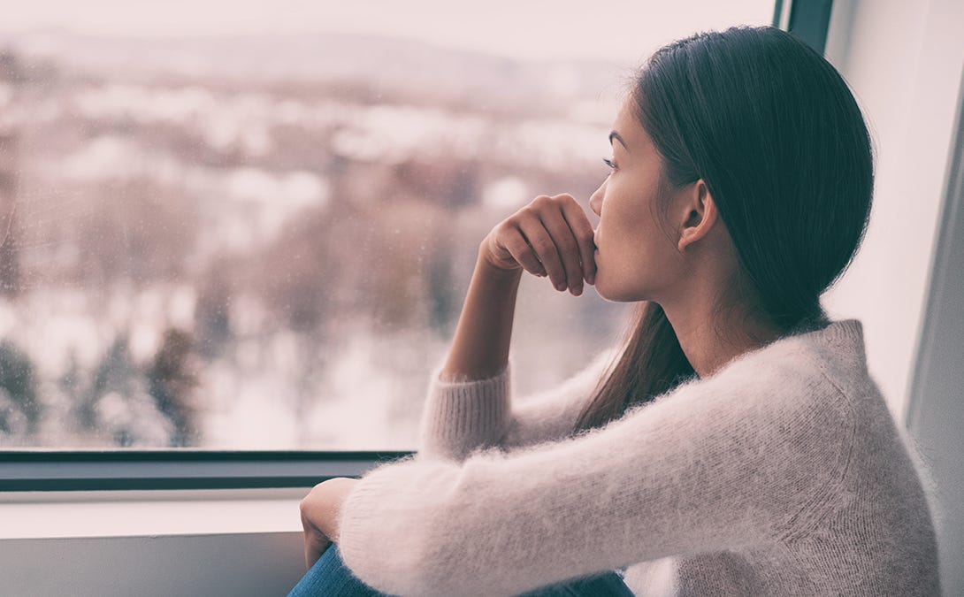 Girl sitting down looking out the window