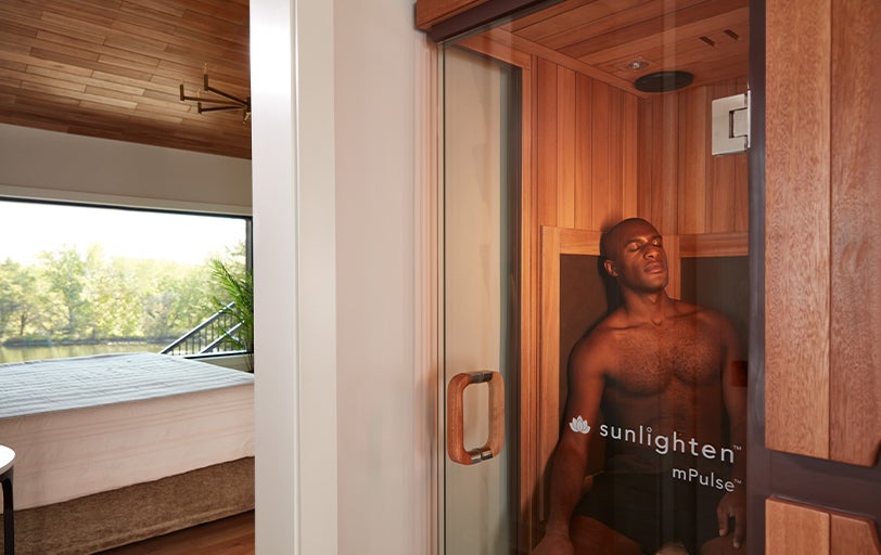 Man relaxing in Sunlighten mPulse Believe sauna.