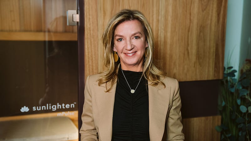 Connie Zack in front of Sunlighten sauna