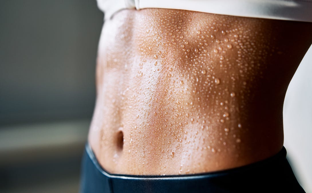 Athletic female's sweating stomach