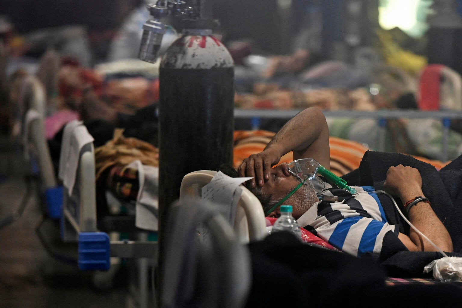 Covid-19 coronavirus positive patients are seen inside a banquet hall temporarily converted into a covid care centre in New Delhi
