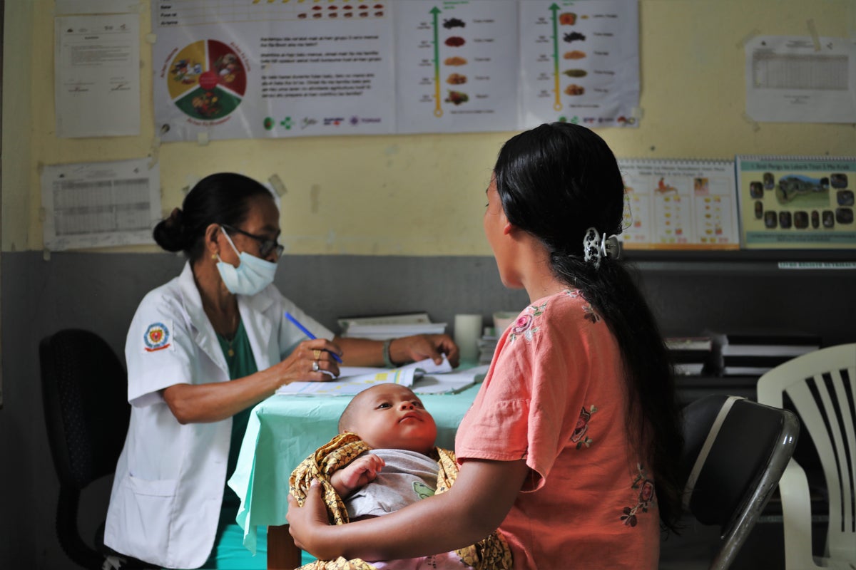 Baby and mother getting a health check in Timor-Leste