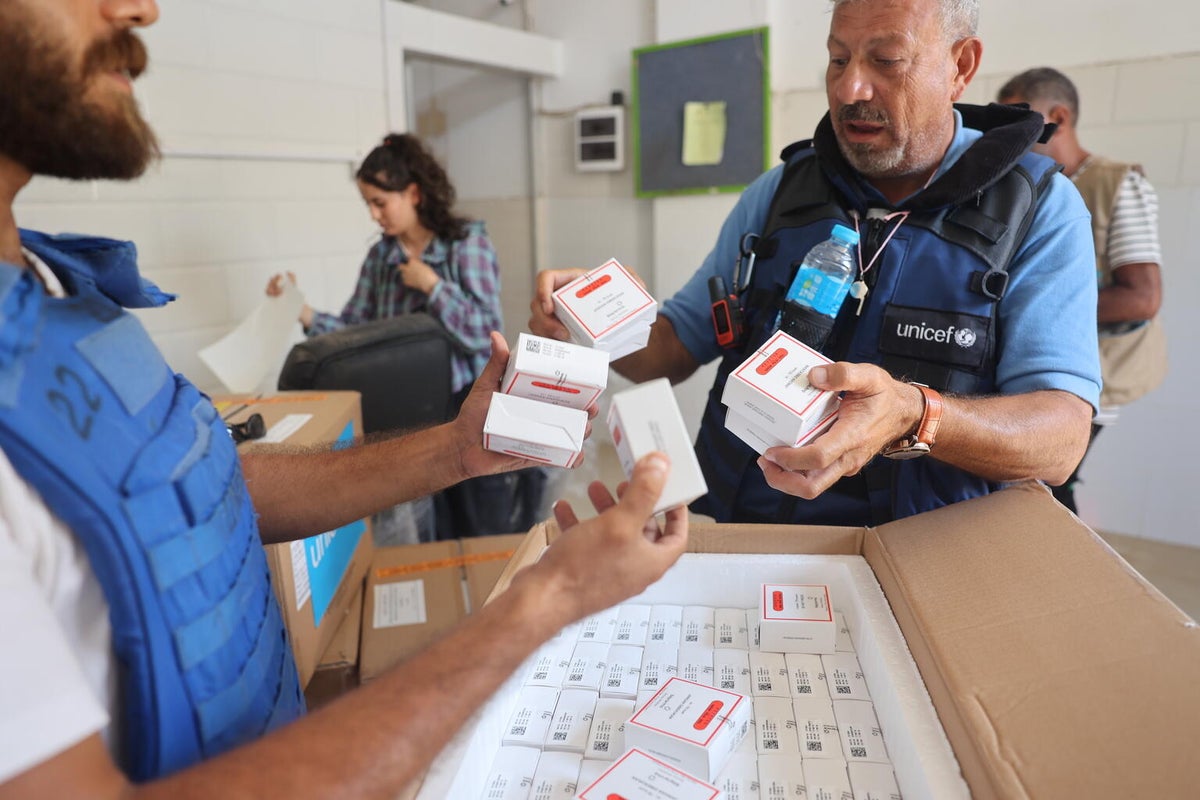 UNICEF staff check oral polio vaccine type 2 (nOPV2) inside the UNICEF warehouse in the Gaza Strip. 