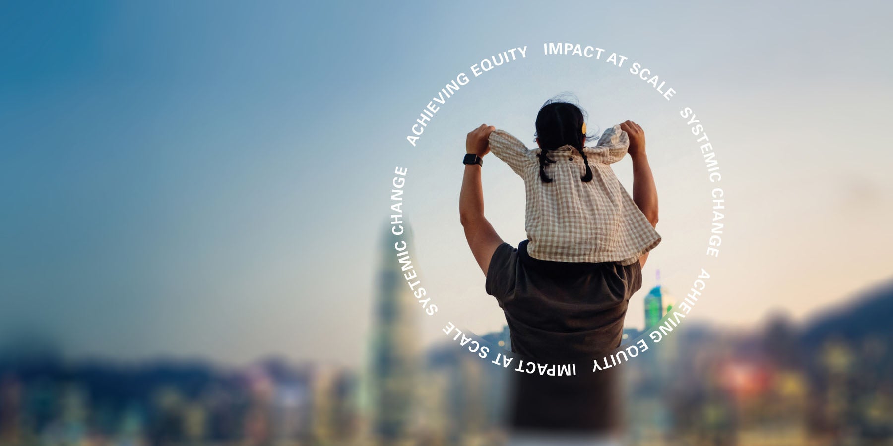 A young girl sits on her father's shoulders, overlooking a city skyline
