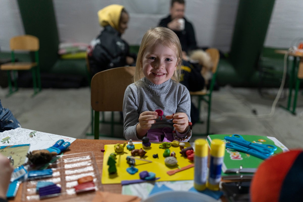 Three-year-old Arina plays with modelling clay and other toys provided by UNICEF inside a 
heated mobile tent in Ukraine.
