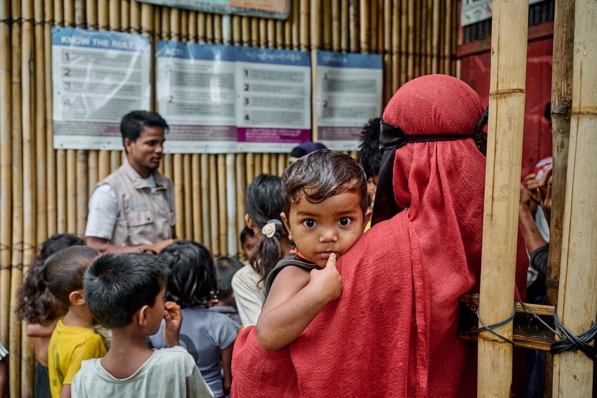 In May 2024, a Rohingya volunteer shares cyclone preparedness messages at a UNICEF-supported centre just hours before Cyclone Remal made landfall. 