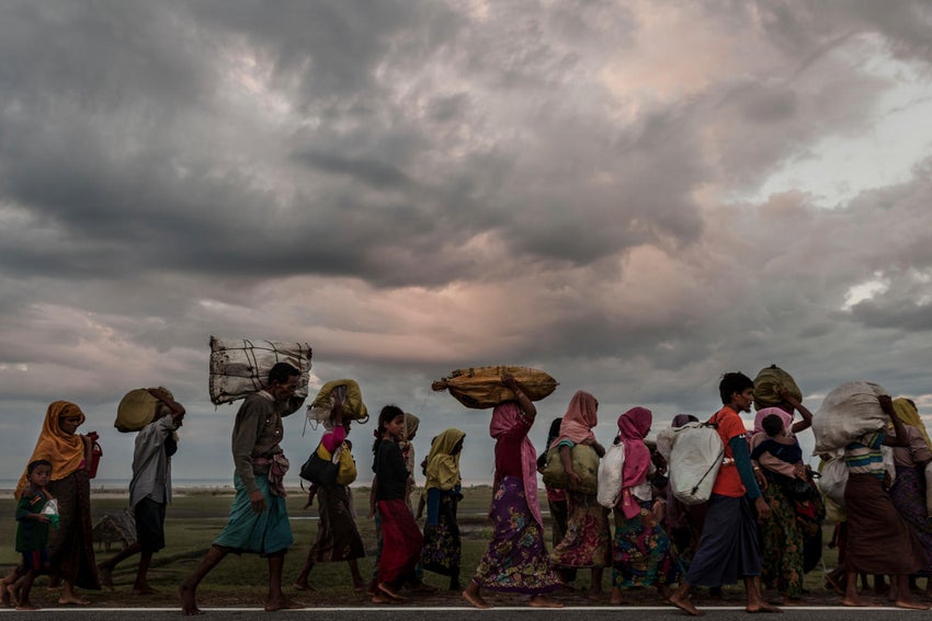 In August 2017, families flee violence and persecution in Myanmar by land and sea. 
