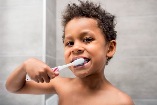 A young boy brushing his teeth