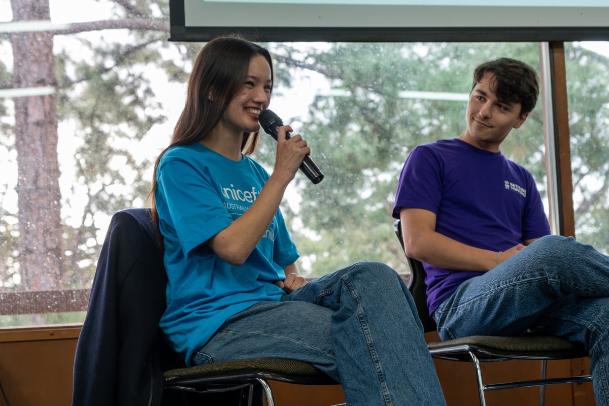 UNICEF Australlia Young Ambassador Layla, wearing a UNICEF Australia tshirt and holding a microphone, speaks during a panel discussion during the Adelaide LCOY.