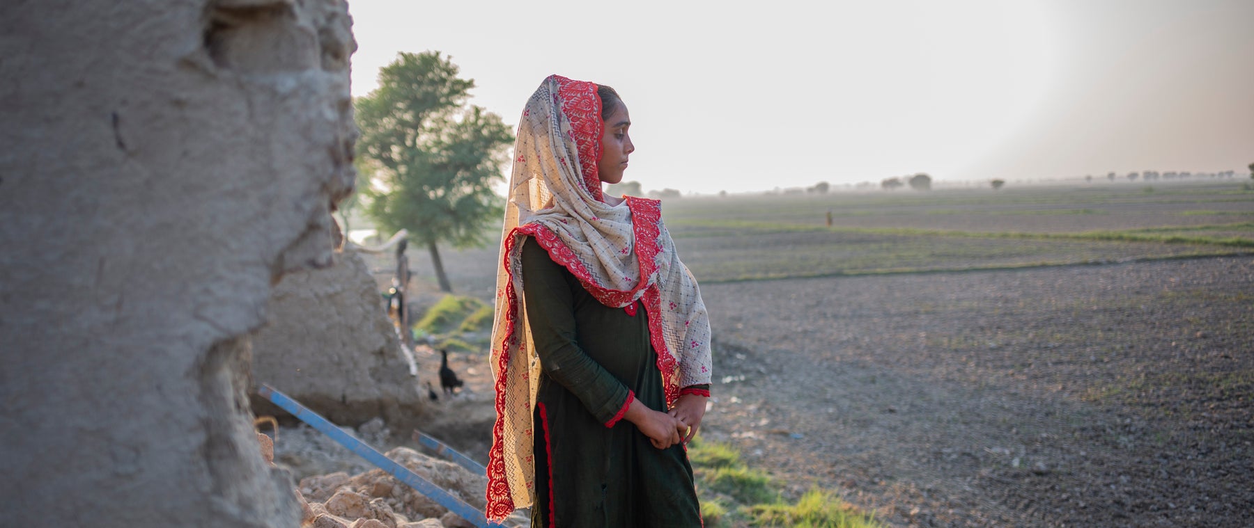 Girl looks out over the flood damaged farm land.