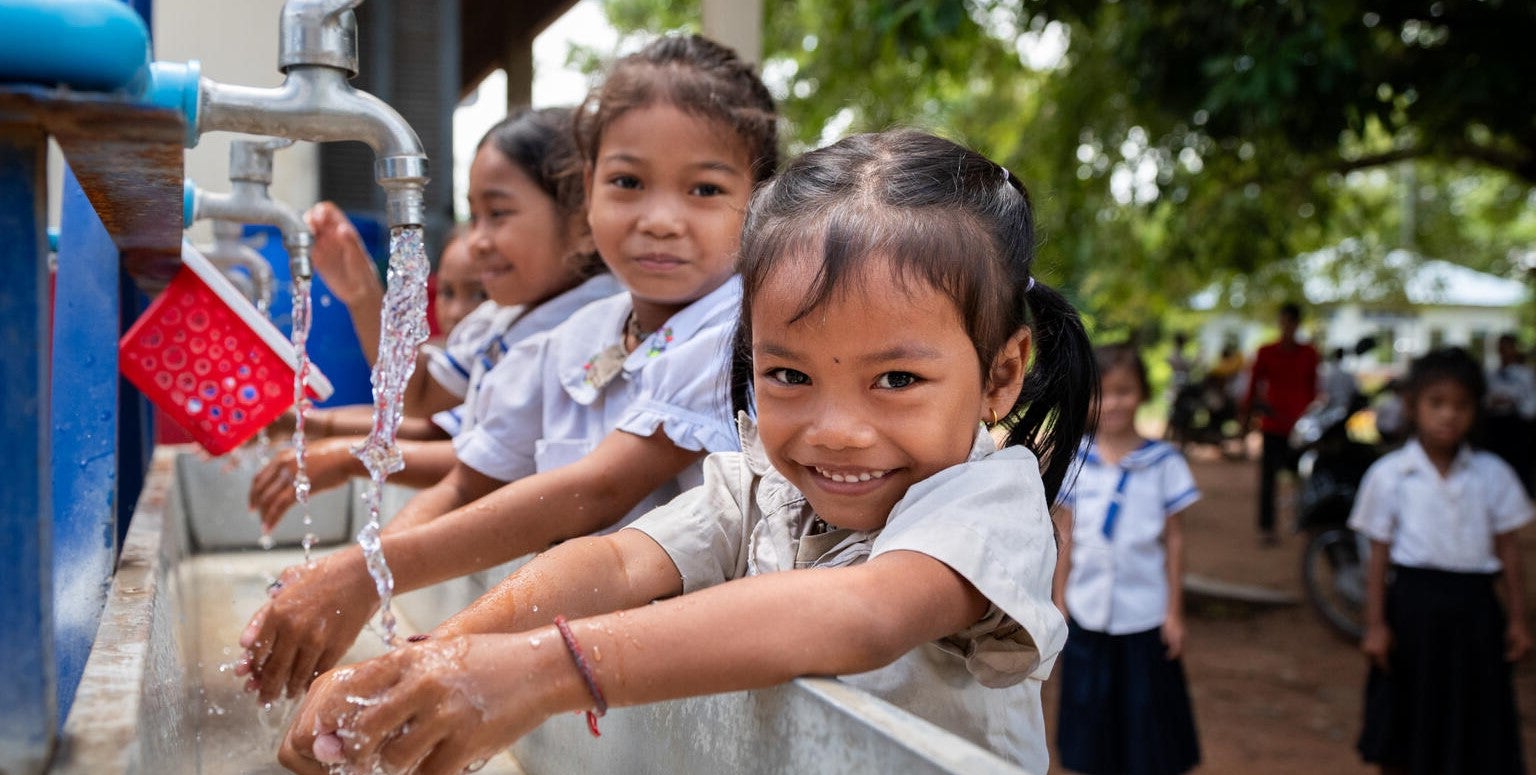 Two students smiling at the camera