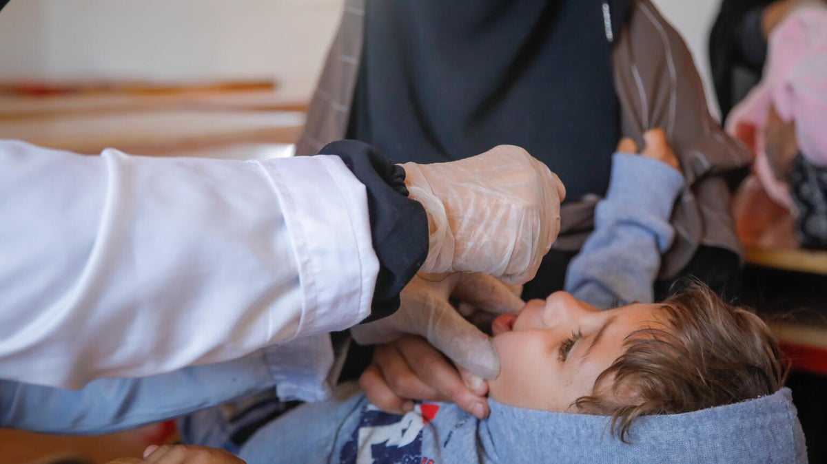 A three-year-old receives treatment at the UNICEF-supported mobile health clinic. 