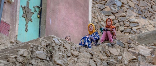 Children sit in front of their homes in a village after the earthquake that struck Morocco in September 2023.