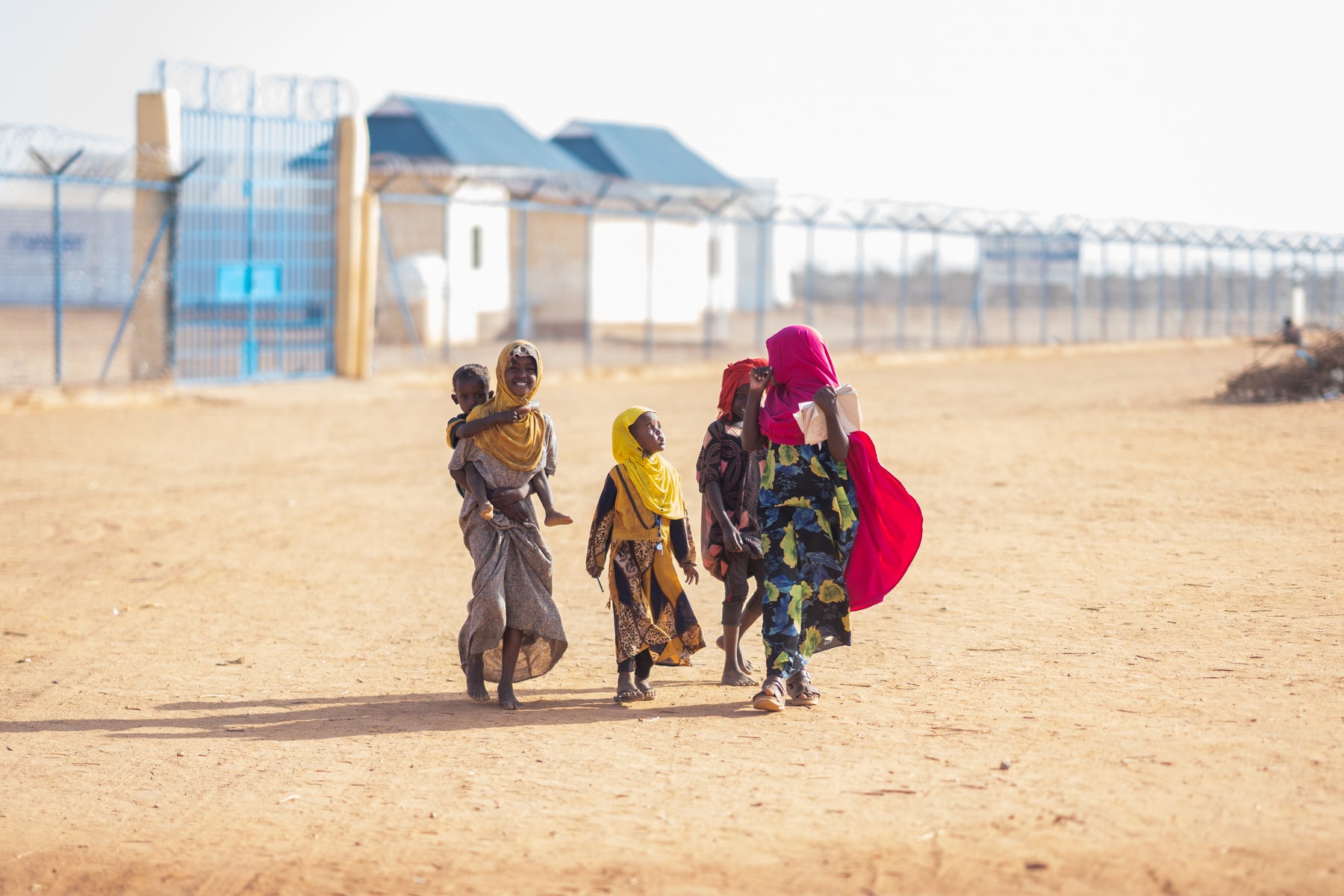 Family walking outside IDP camp.