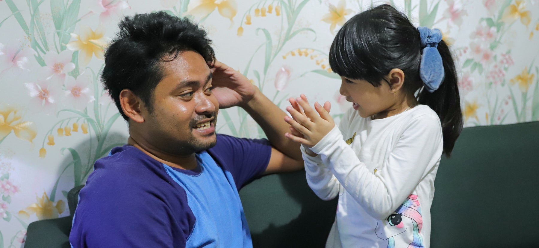 Father and daughter smiling