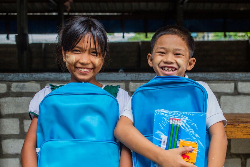 School girls in Myanmar holding school bags.