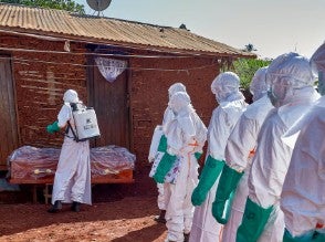 People lined up in PPE.